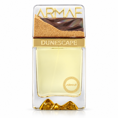 Botella de Dunescape de Armaf con líquido amarillo claro, detalles dorados y tapa decorada con dunas, sobre fondo blanco.